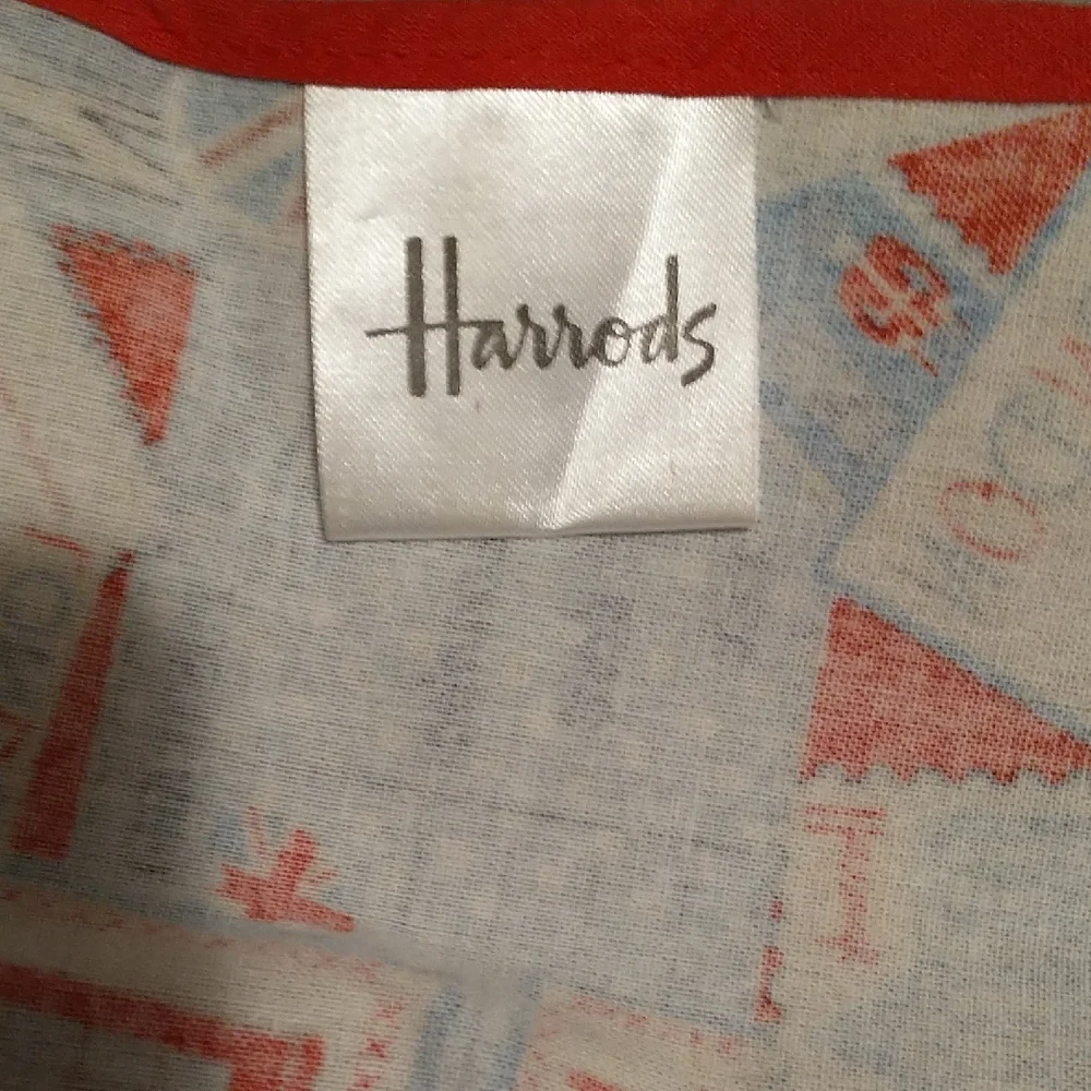 Harrods Red, Blue and White Vinyl Baby Bib with London Postcard Print